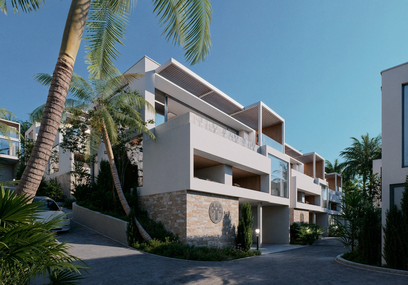 IO Villas — exterior facade with tropical landscaping at dusk
